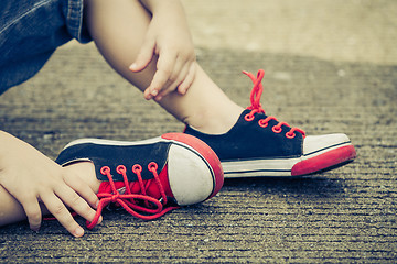 Image showing youth sneakers on boy legs on road