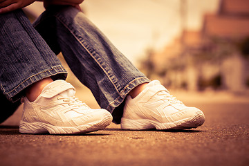 Image showing youth sneakers on girl legs on road