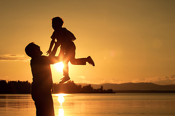 Image showing father and son playing on the coast of lake