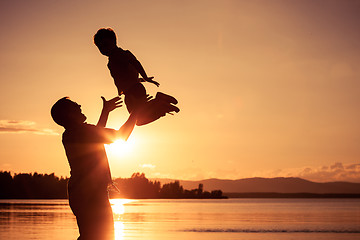 Image showing father and son playing on the coast of lake