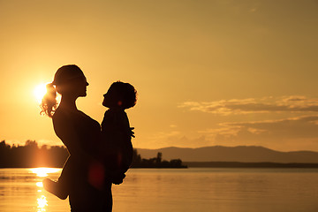 Image showing Mother and son playing on the coast of lake