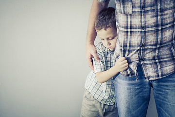 Image showing sad son hugging his dad