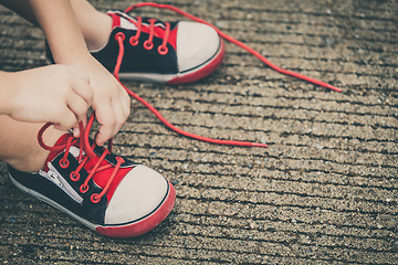 Image showing youth sneakers on boy legs on road