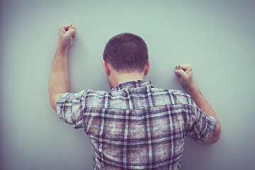 Image showing portrait one sad man standing near a wall 