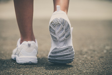 Image showing youth sneakers on girl legs on road