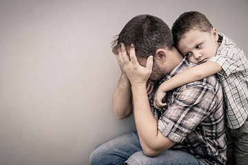 Image showing sad son hugging his dad