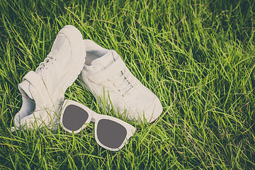 Image showing youth sneakers on the grass