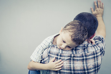 Image showing sad son hugging his dad