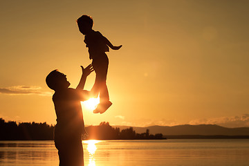 Image showing father and son playing on the coast of lake