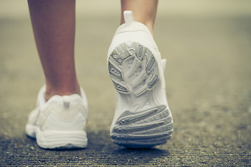 Image showing youth sneakers on girl legs on road