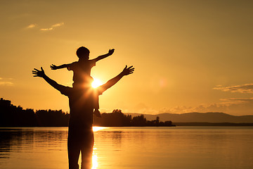 Image showing father and son playing on the coast of lake