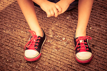 Image showing youth sneakers on boy legs on road