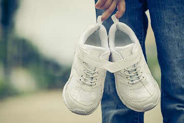 Image showing youth sneakers on girl legs on road