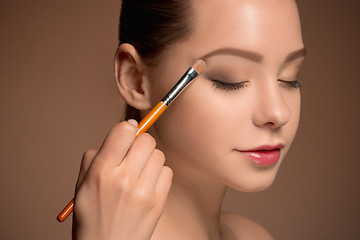 Image showing Beauty Girl with Makeup Brush. Perfect Skin. Applying Makeup