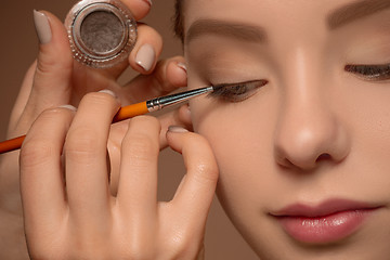 Image showing Beautiful female eyes with make-up and brush