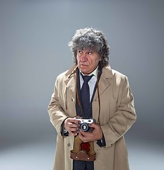 Image showing The senior man as detective or boss of mafia on gray studio background