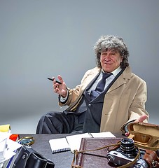 Image showing The senior man as detective or boss of mafia on gray studio background