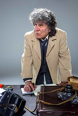 Image showing The senior man as detective or boss of mafia on gray studio background