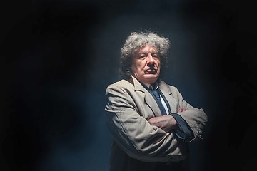 Image showing The senior man as detective or boss of mafia on gray studio background