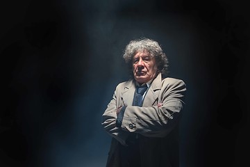 Image showing The senior man as detective or boss of mafia on gray studio background