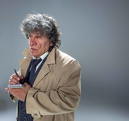 Image showing The senior man as detective or boss of mafia on gray studio background