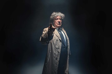 Image showing The senior man as detective or boss of mafia on gray studio background