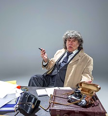 Image showing The senior man as detective or boss of mafia on gray studio background