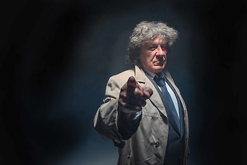 Image showing The senior man as detective or boss of mafia on gray studio background