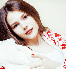 Image showing young pretty brunette girl in Christmas ornament blanket getting warm on cold winter, freshness beauty concept close