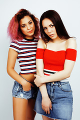 Image showing lifestyle people concept: two pretty stylish modern hipster teen girl having fun together, diverse nation mixed races, happy smiling making selfie closeup