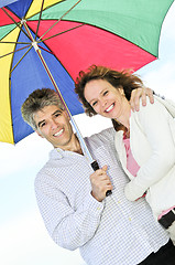 Image showing Happy mature couple with umbrella