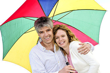 Image showing Happy mature couple with umbrella