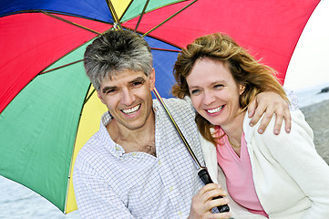 Image showing Happy mature couple with umbrella