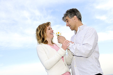 Image showing Mature romantic couple with flowers