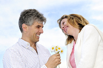 Image showing Mature romantic couple with flowers