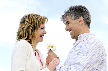 Image showing Mature romantic couple with flowers