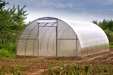 Image showing A small greenhouse in the garden.