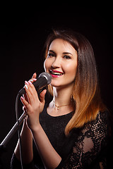 Image showing Girl with microphone in studio