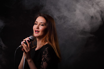 Image showing Singing girl background of smoke