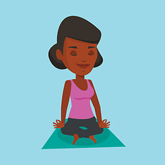 Image showing Woman meditating in yoga lotus pose.