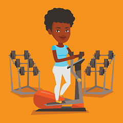 Image showing Woman exercising on elliptical trainer.