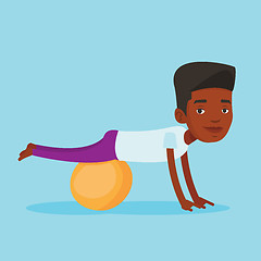 Image showing Young man exercising with fitball.