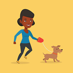 Image showing Young woman walking with her dog.