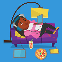 Image showing Woman lying on sofa with many gadgets.