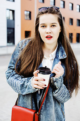 Image showing young pretty hipster girl student with coffee cup posing adorable smiling, lifestyle people concept outdoor