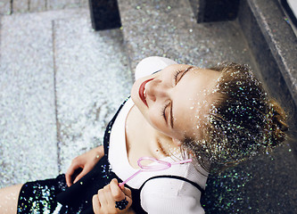 Image showing young pretty party girl smiling covered with glitter tinsel, fas