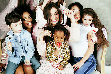 Image showing Lifestyle and people concept: young pretty diversity nations woman with different age children celebrating on birth day party together happy smiling, making selfie. African-american, asian and caucasi