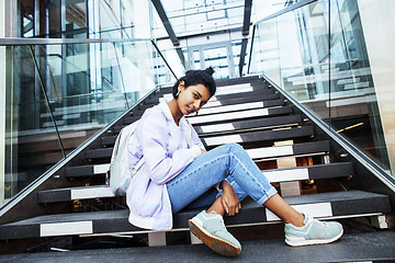 Image showing young cute indian girl at university building sitting on stairs 