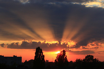 Image showing summer sunset with dark sky and sunny beams