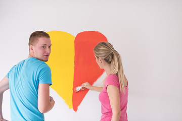 Image showing couple are painting a heart on the wall